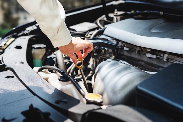 Person checking things under the hood